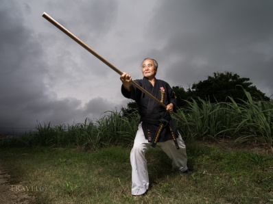 Seiyu Nakamura, 10th Dan Okinawa Dentou Shidokan Karate and Kobujutsu. Training with bo staff outside his dojo in Kochinda, Okinawa, Japan.