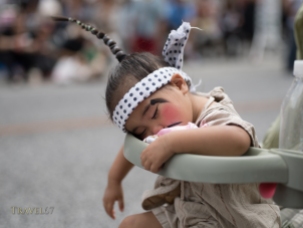 Young child in chondara costume sleeping through the Ryukyu Dynasty’s procession at Kokusai Street, Naha.